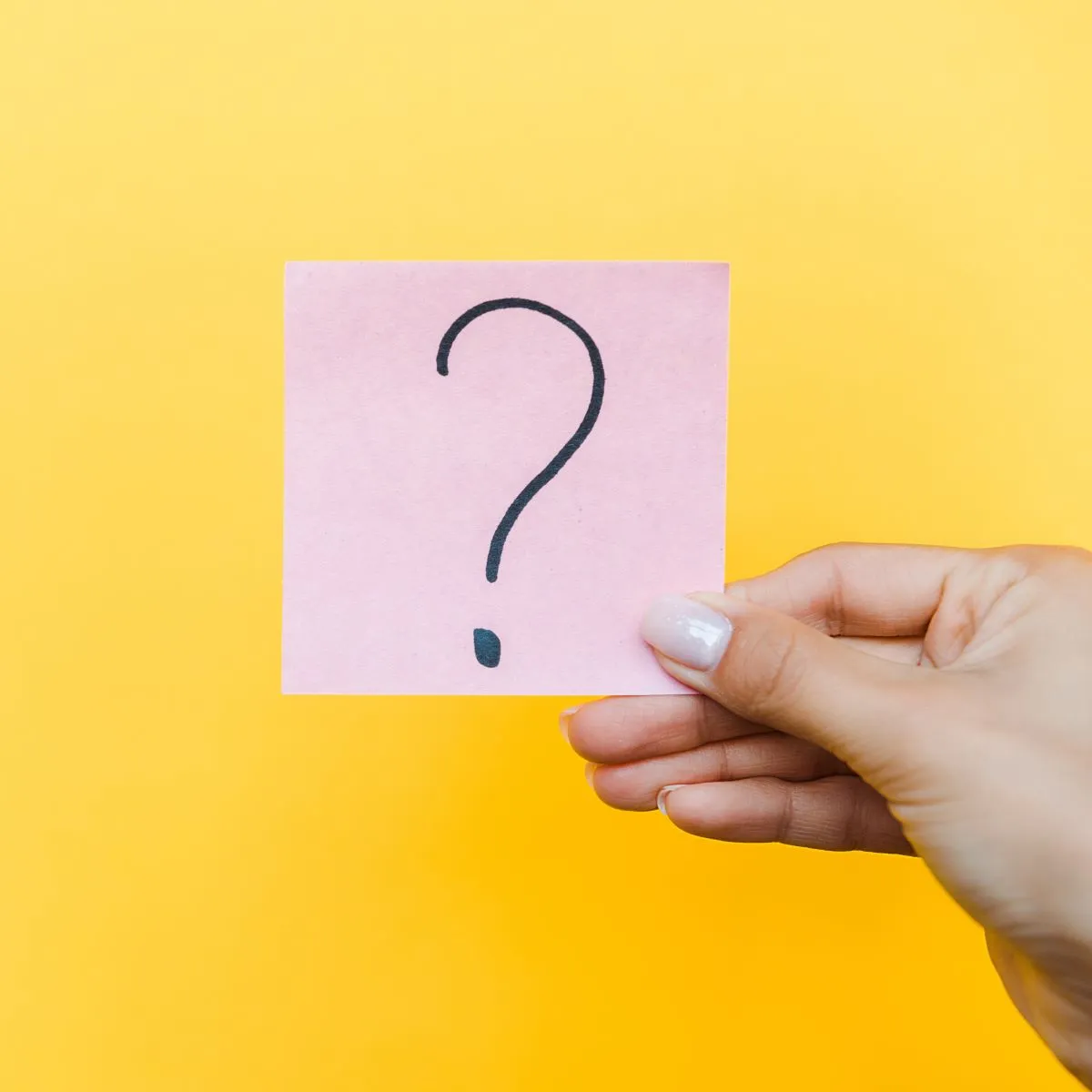 Women holding a paper with question mark