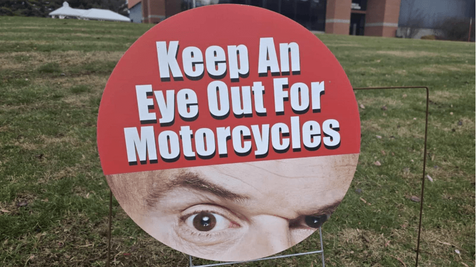 Keep An Eye Out For Motorcycles - roadside sign with Tim Misny's eye raise.